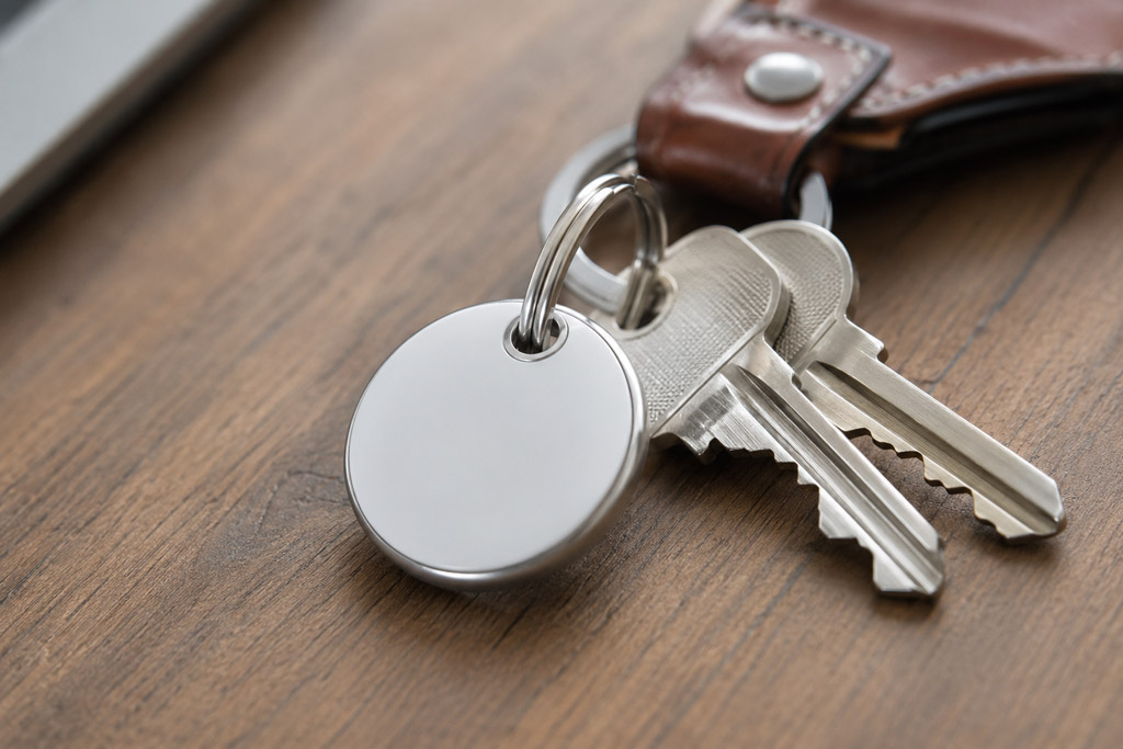 Apple AirTag Bluetooth tracker attached to a set of keys